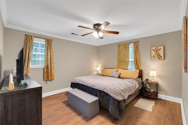 bedroom with light wood-style floors, visible vents, and baseboards