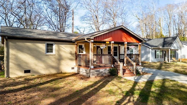 view of front of property featuring crawl space, brick siding, covered porch, and a shingled roof