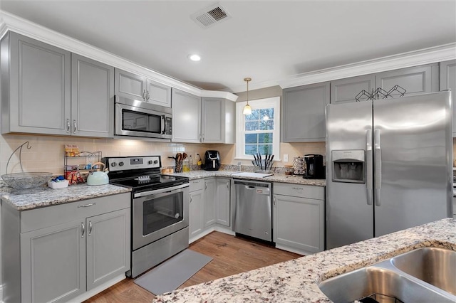 kitchen with light wood-type flooring, stainless steel appliances, visible vents, and gray cabinets