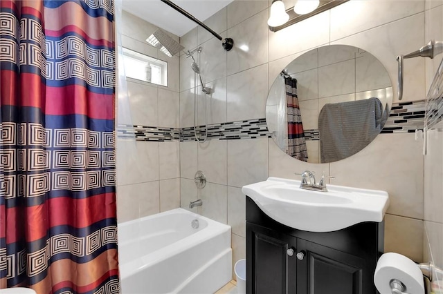 bathroom featuring tile walls, vanity, and shower / bathtub combination with curtain