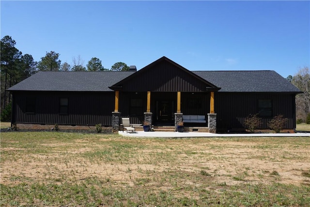 view of front of property featuring a front lawn and board and batten siding