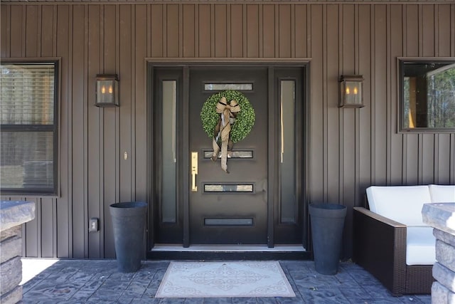 view of exterior entry featuring board and batten siding