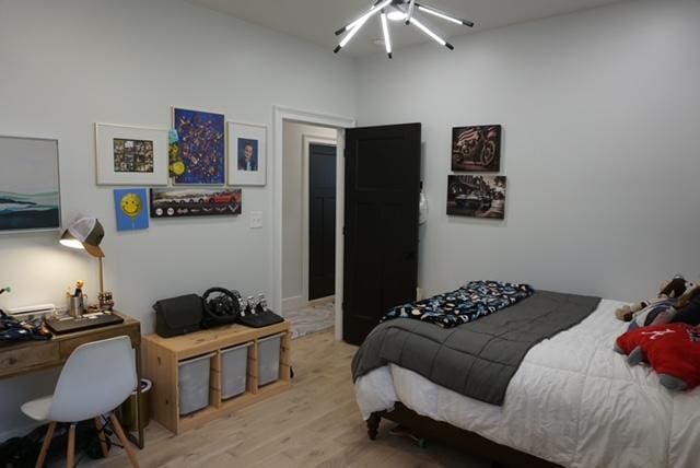 bedroom with a ceiling fan and light wood finished floors