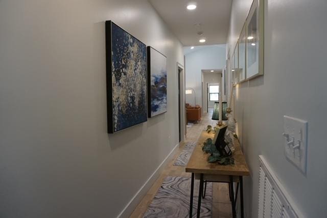 hall featuring recessed lighting, visible vents, and baseboards