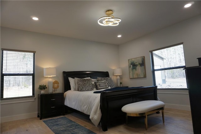 bedroom with recessed lighting, baseboards, and light wood-style floors