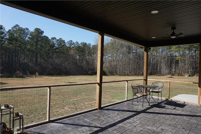 view of patio / terrace with a forest view and ceiling fan