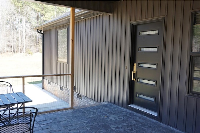 view of exterior entry with board and batten siding