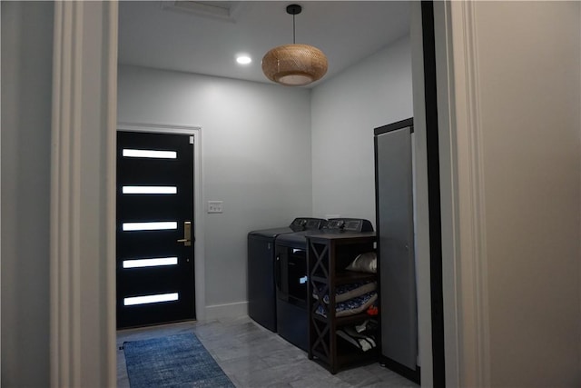 clothes washing area with recessed lighting, separate washer and dryer, and laundry area