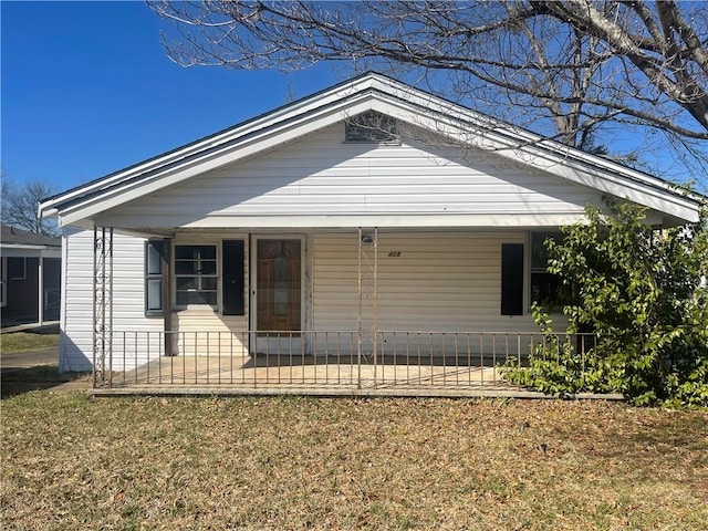 bungalow-style home with a fenced front yard and a porch