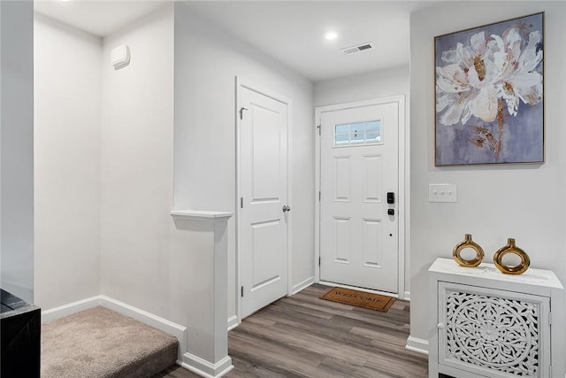 entrance foyer with visible vents, baseboards, and wood finished floors