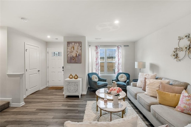 living room featuring recessed lighting, baseboards, and wood finished floors