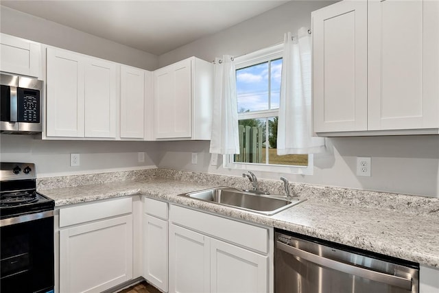 kitchen featuring a sink, light countertops, white cabinetry, and stainless steel appliances