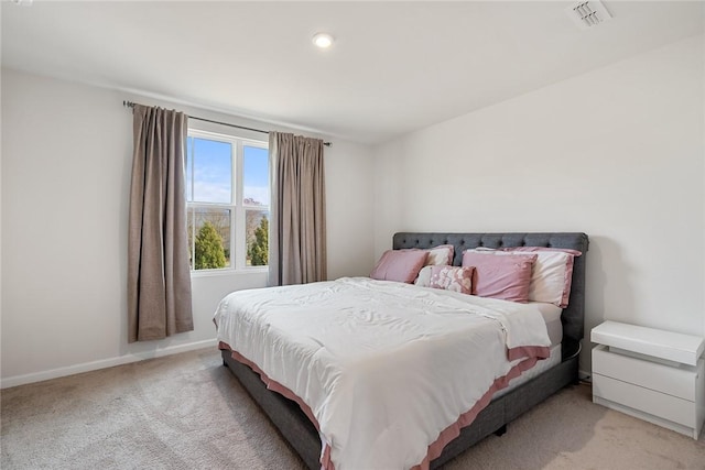 bedroom featuring visible vents, light carpet, and baseboards