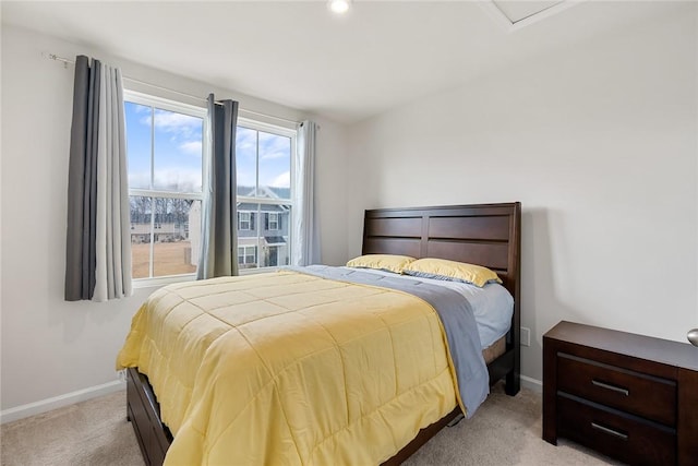 bedroom featuring baseboards and light colored carpet