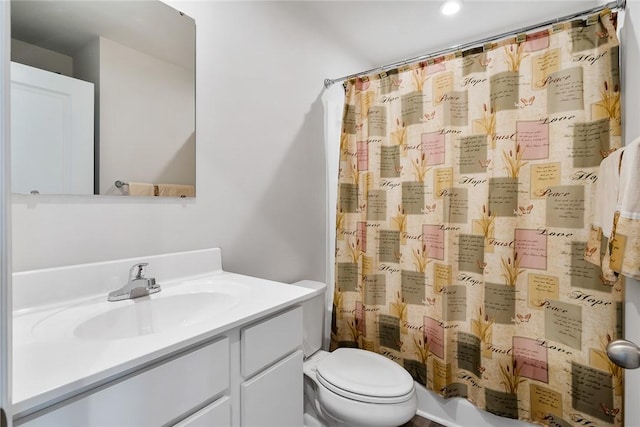 bathroom featuring vanity, a shower with shower curtain, and toilet