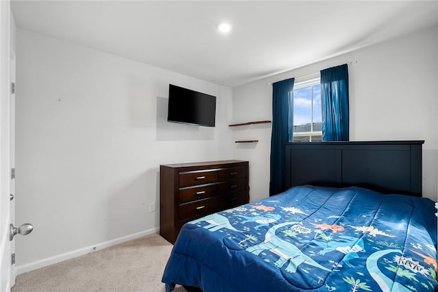 bedroom featuring baseboards and carpet