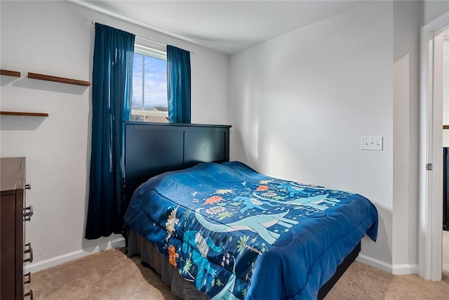 carpeted bedroom featuring baseboards