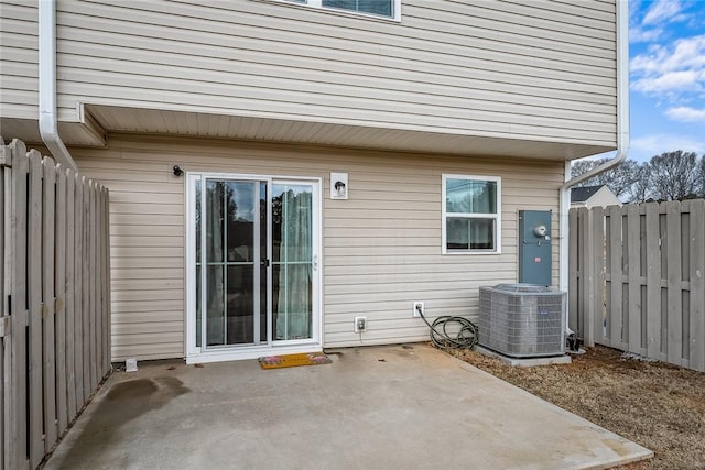 view of patio featuring central air condition unit and fence