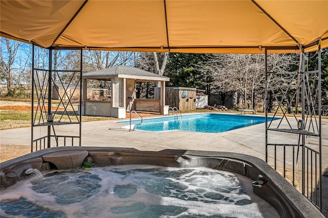 view of swimming pool with a gazebo, a fenced in pool, an outdoor hot tub, and a patio area