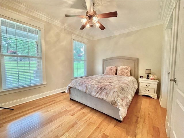 bedroom with baseboards, wood finished floors, and ornamental molding