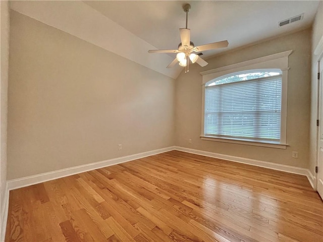 unfurnished room featuring visible vents, baseboards, light wood-style floors, and a ceiling fan