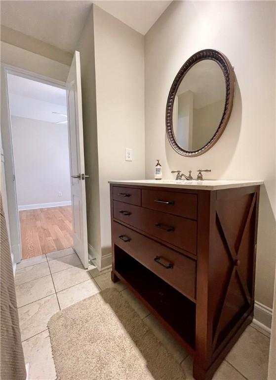 bathroom featuring baseboards, vanity, and tile patterned flooring