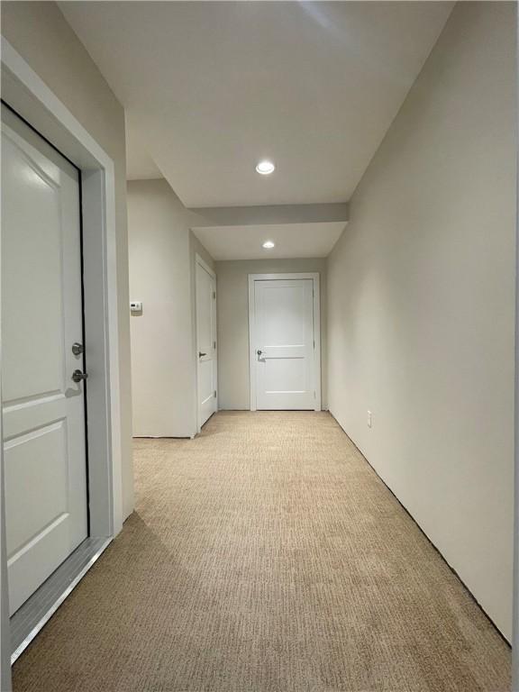 unfurnished room with recessed lighting and light carpet