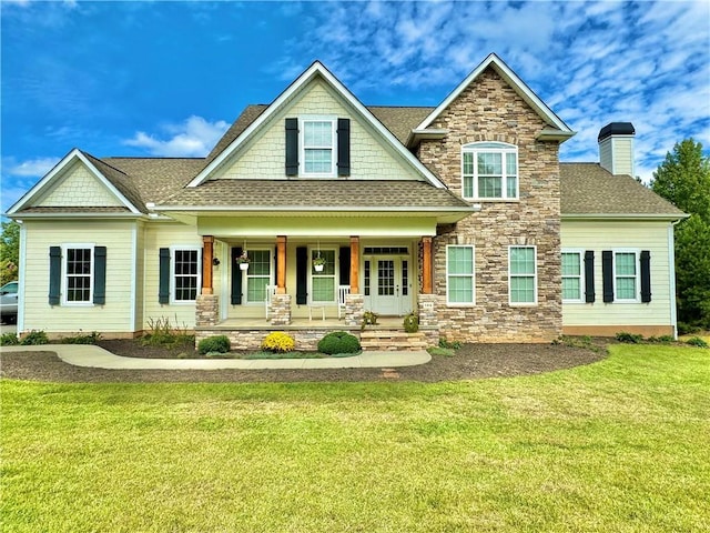 craftsman-style house with a porch, a front yard, roof with shingles, a chimney, and stone siding