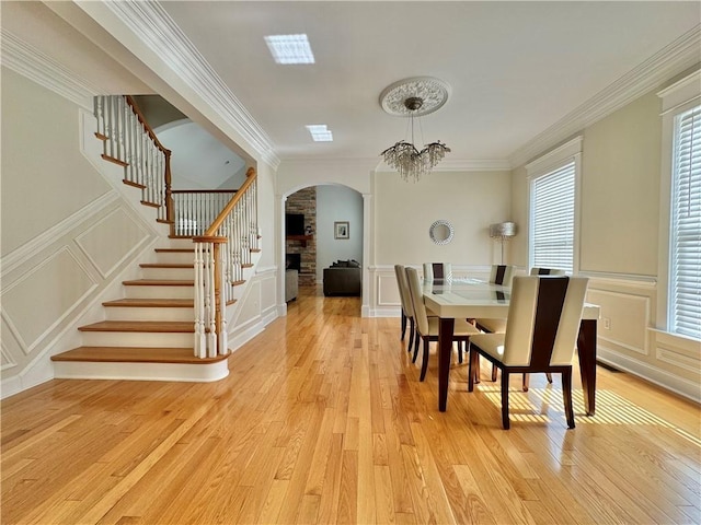 dining room featuring a decorative wall, stairs, and ornamental molding