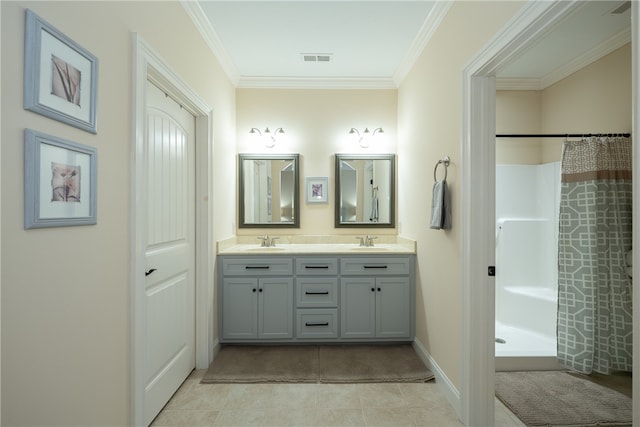 bathroom with crown molding, double vanity, visible vents, and a sink