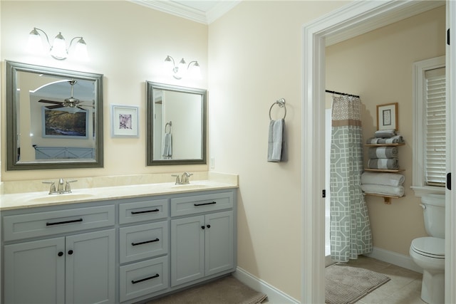 bathroom featuring a sink, toilet, ornamental molding, and double vanity