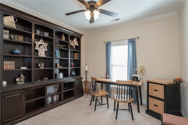 office featuring visible vents, light colored carpet, ornamental molding, and a ceiling fan