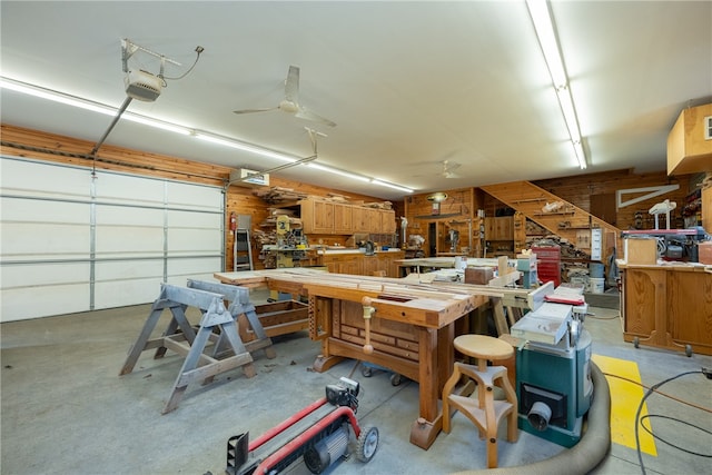 garage featuring a workshop area, a garage door opener, and ceiling fan