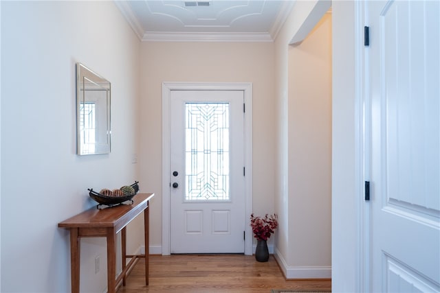 foyer entrance with crown molding, baseboards, and light wood-type flooring