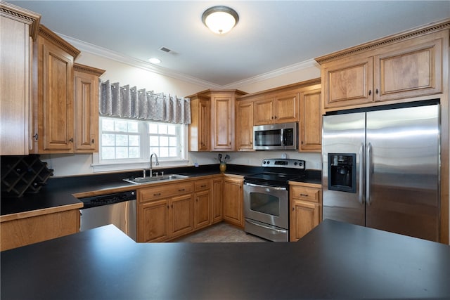 kitchen featuring visible vents, ornamental molding, a sink, appliances with stainless steel finishes, and dark countertops