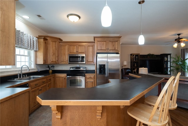 kitchen with a sink, dark countertops, visible vents, and stainless steel appliances