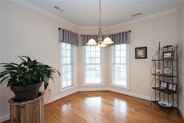 dining area with visible vents, crown molding, and wood finished floors