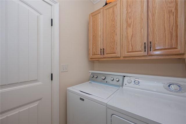 laundry area featuring washer and clothes dryer and cabinet space