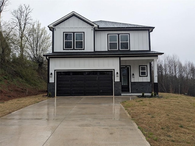 modern inspired farmhouse featuring concrete driveway, a garage, board and batten siding, and stone siding