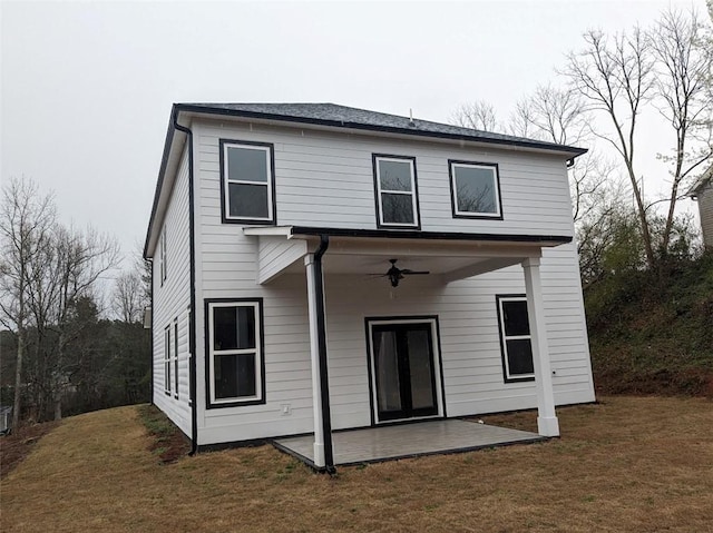 rear view of house featuring a lawn, a ceiling fan, and a patio area