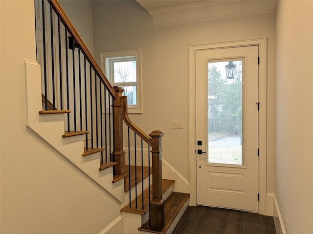 doorway to outside with baseboards, dark wood-type flooring, ornamental molding, and stairs