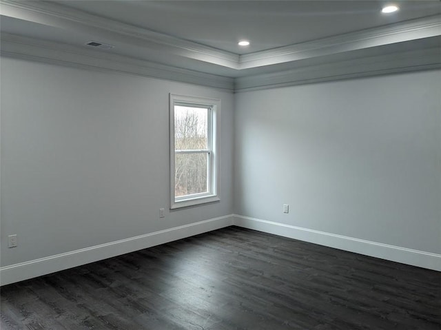 spare room with crown molding, baseboards, and dark wood-style flooring