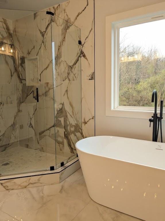 full bathroom featuring a marble finish shower, a soaking tub, and marble finish floor