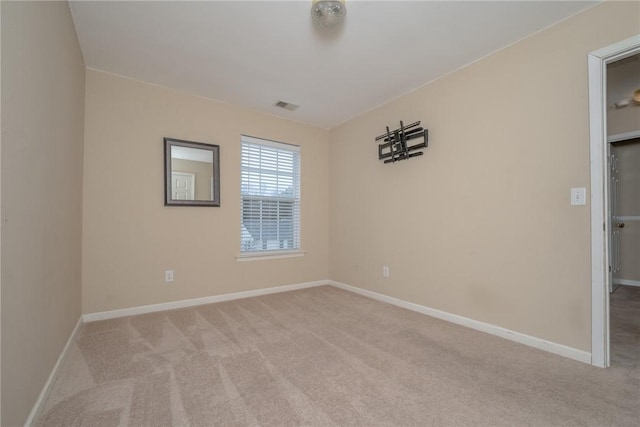 empty room with visible vents, baseboards, and carpet