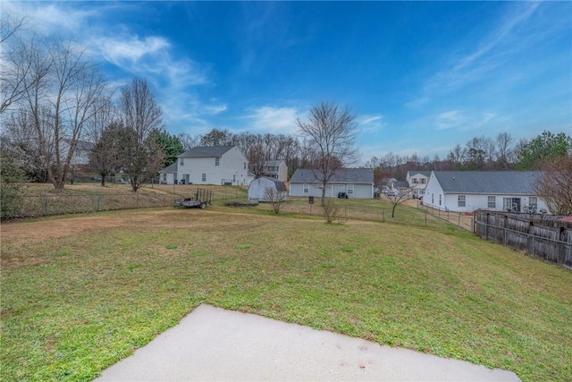 view of yard with a residential view and a fenced backyard