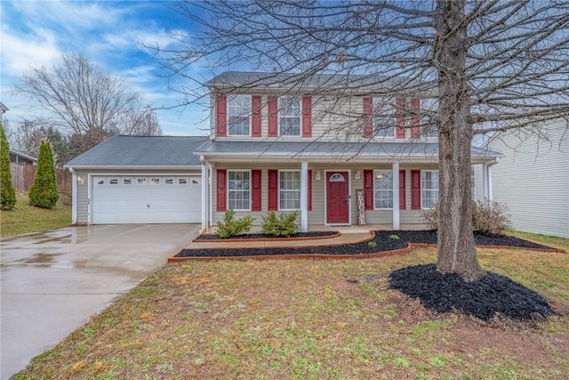 traditional-style home with an attached garage, driveway, and a front lawn