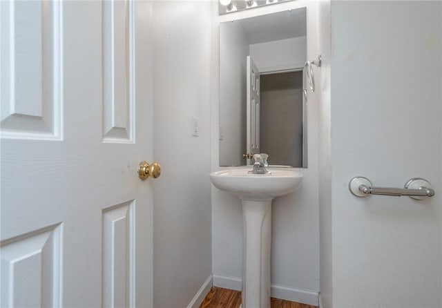 bathroom featuring wood finished floors and baseboards