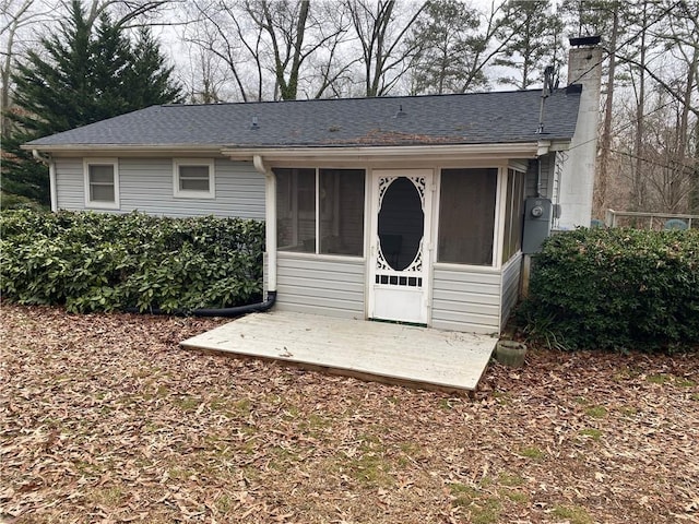 view of outbuilding featuring a sunroom