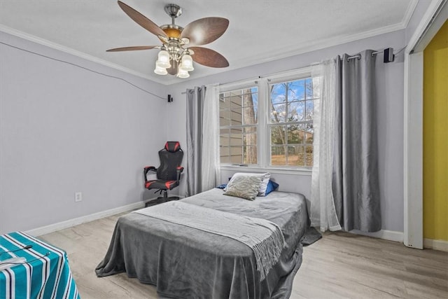 bedroom with ceiling fan, ornamental molding, baseboards, and light wood-type flooring