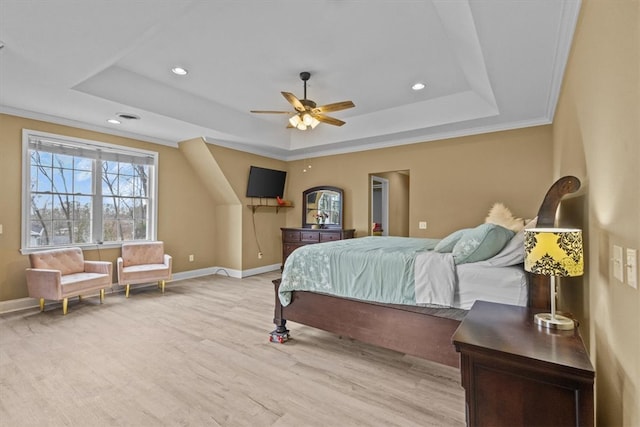 bedroom with recessed lighting, a tray ceiling, baseboards, and wood finished floors